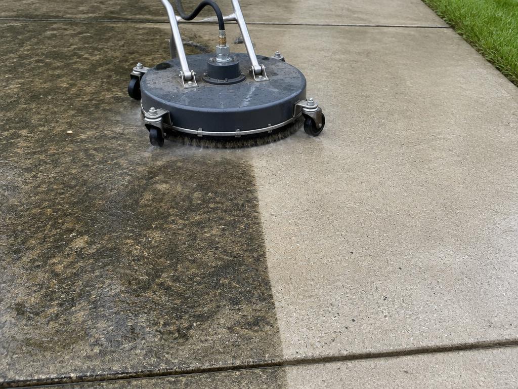 Surface cleaner removing grime from a concrete driveway